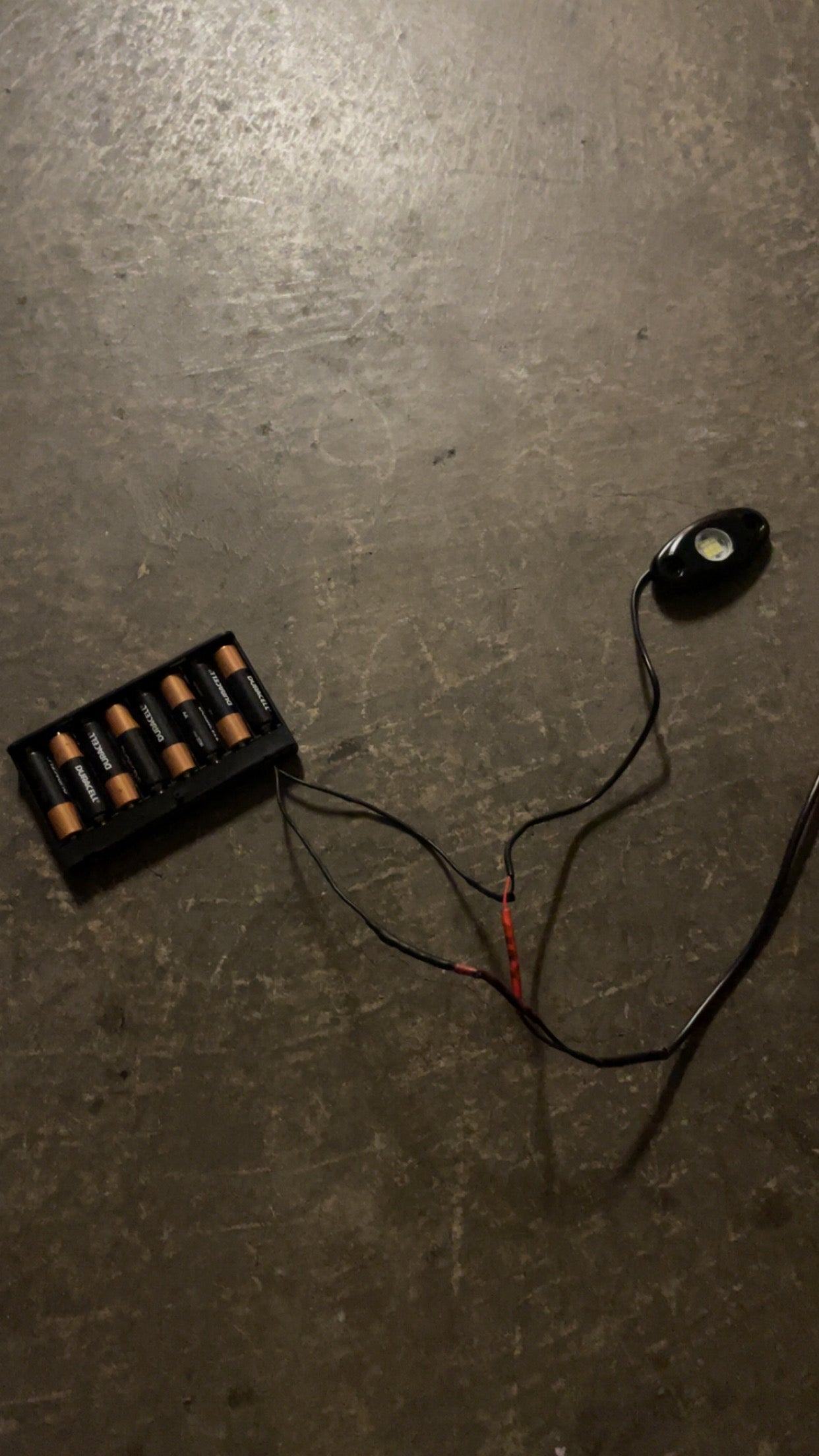 Hidden battery powered rock light switch